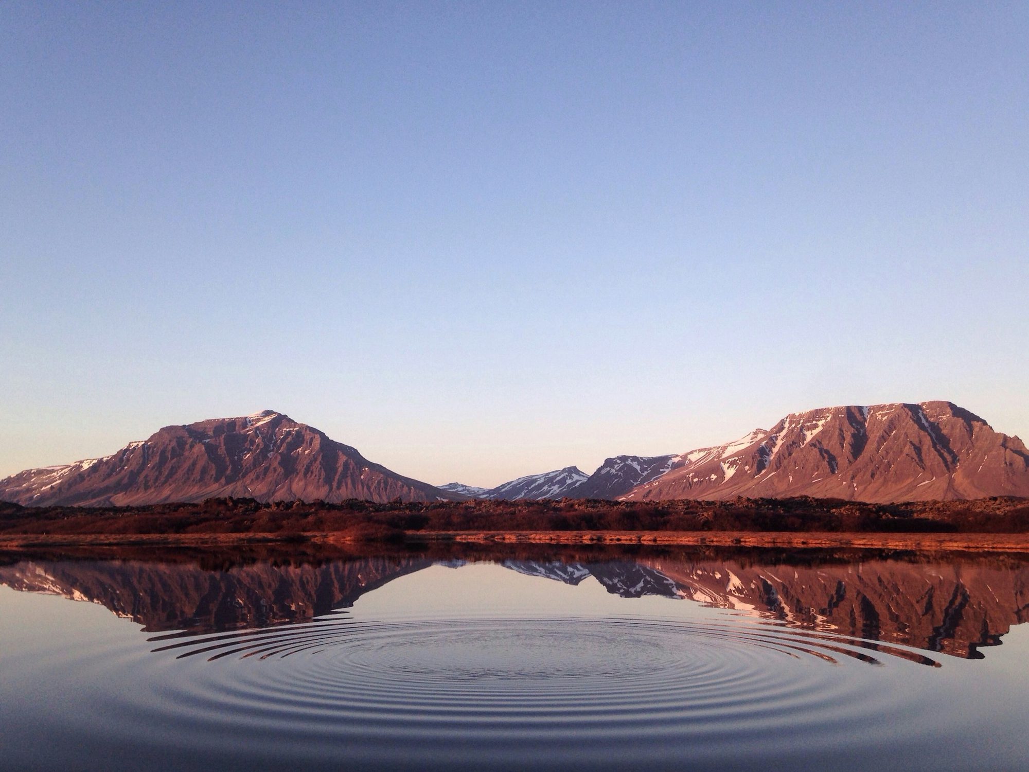 Mountains at dusk reflected in still water